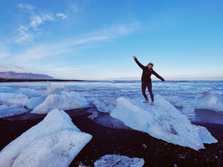 happy woman posing on a ice block at Diamond Beach in Iceland