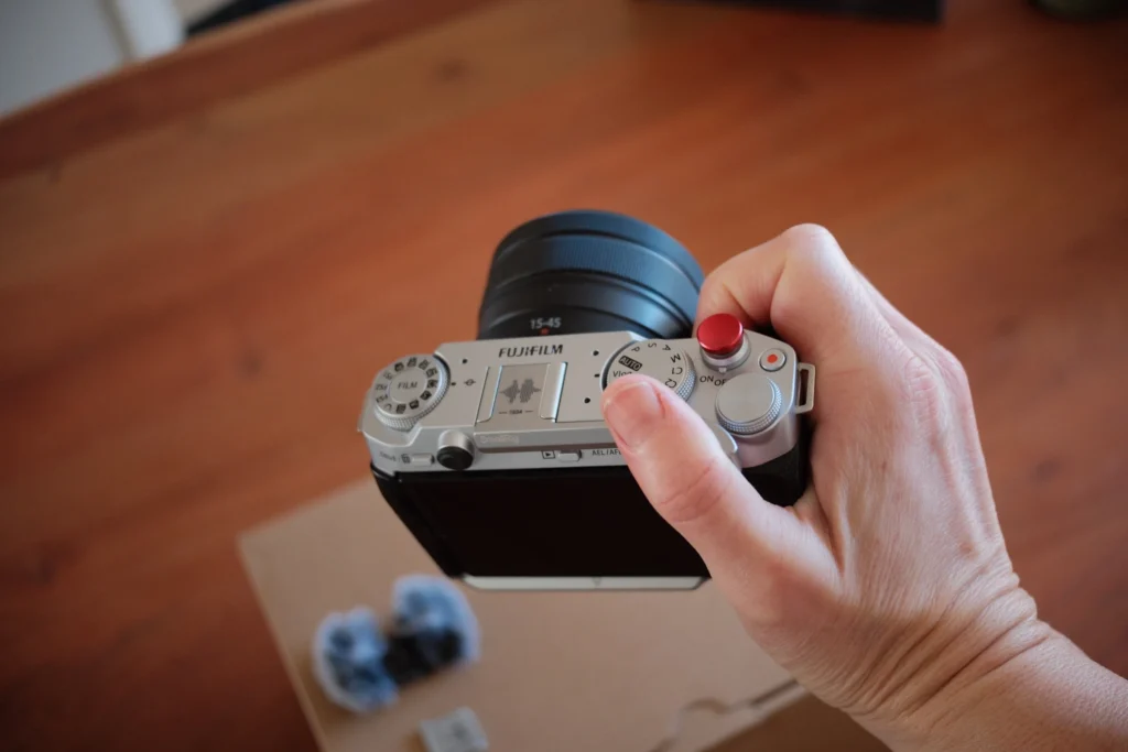 Photo of the Fujifilm X-M5 in-hand illustrating it's small size.